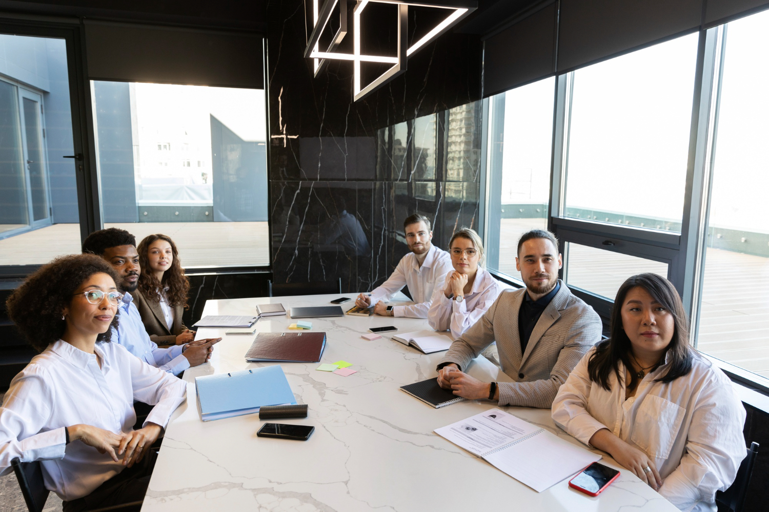 diretores encarando funcionário que propoe viagem como benefício